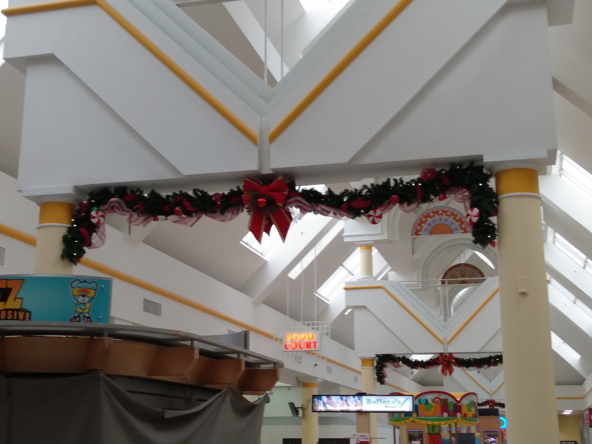 Commercial plaza decorated with holiday garland and lights